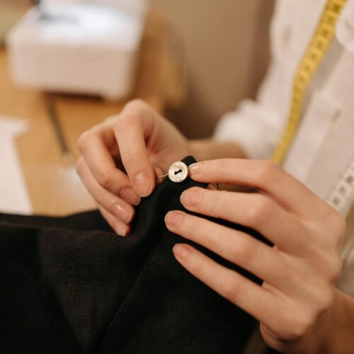 Sew on knot by hand.